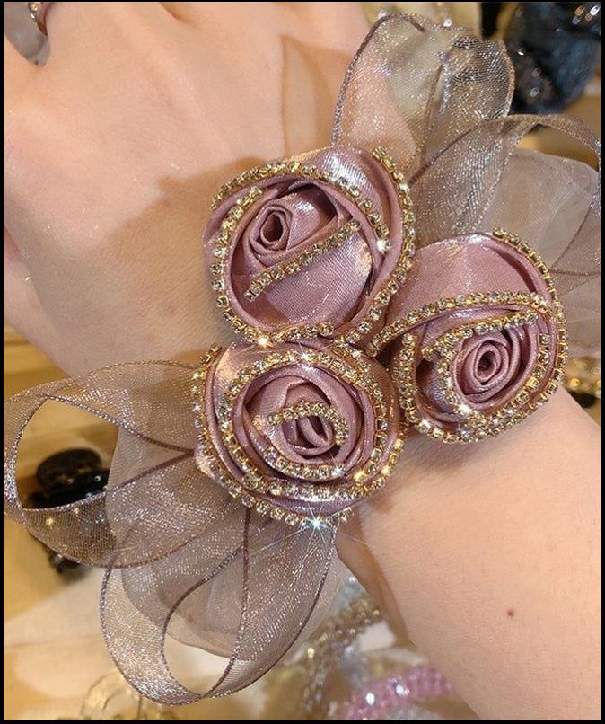 a woman is holding a bouquet of pink roses