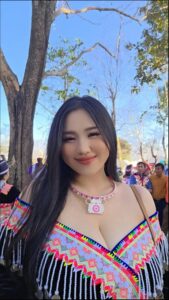 a woman dressed in a pink dress standing next to a group of people