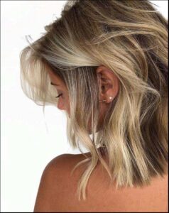 a woman with a black hair and a red neck tie