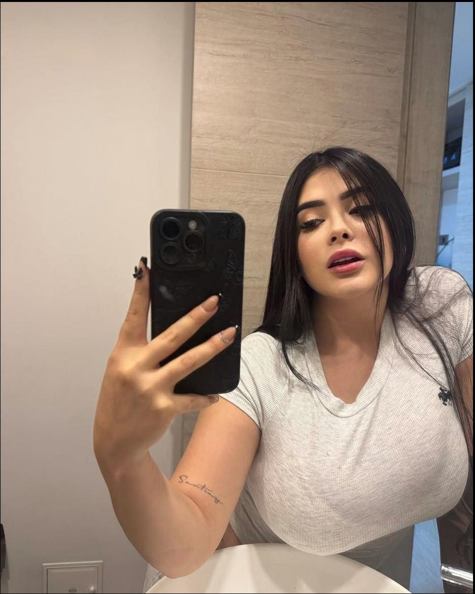 a woman is holding a cell phone in front of her face