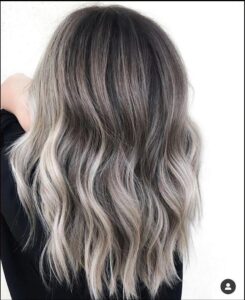 a woman is looking at the camera while wearing a black shirt