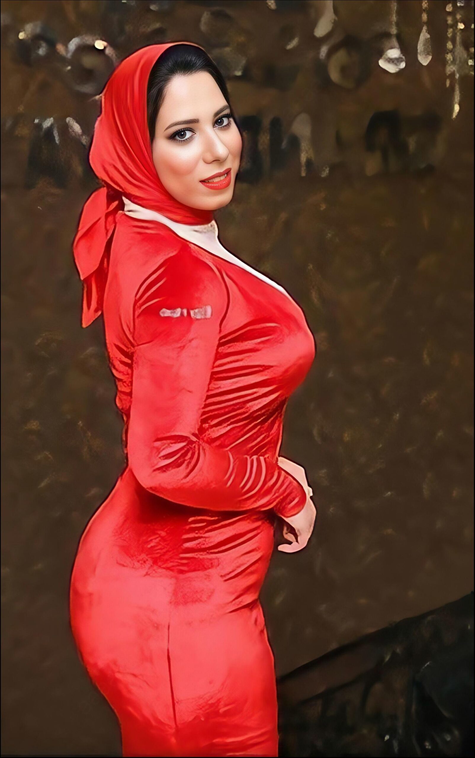 a woman in a red dress posing for a picture