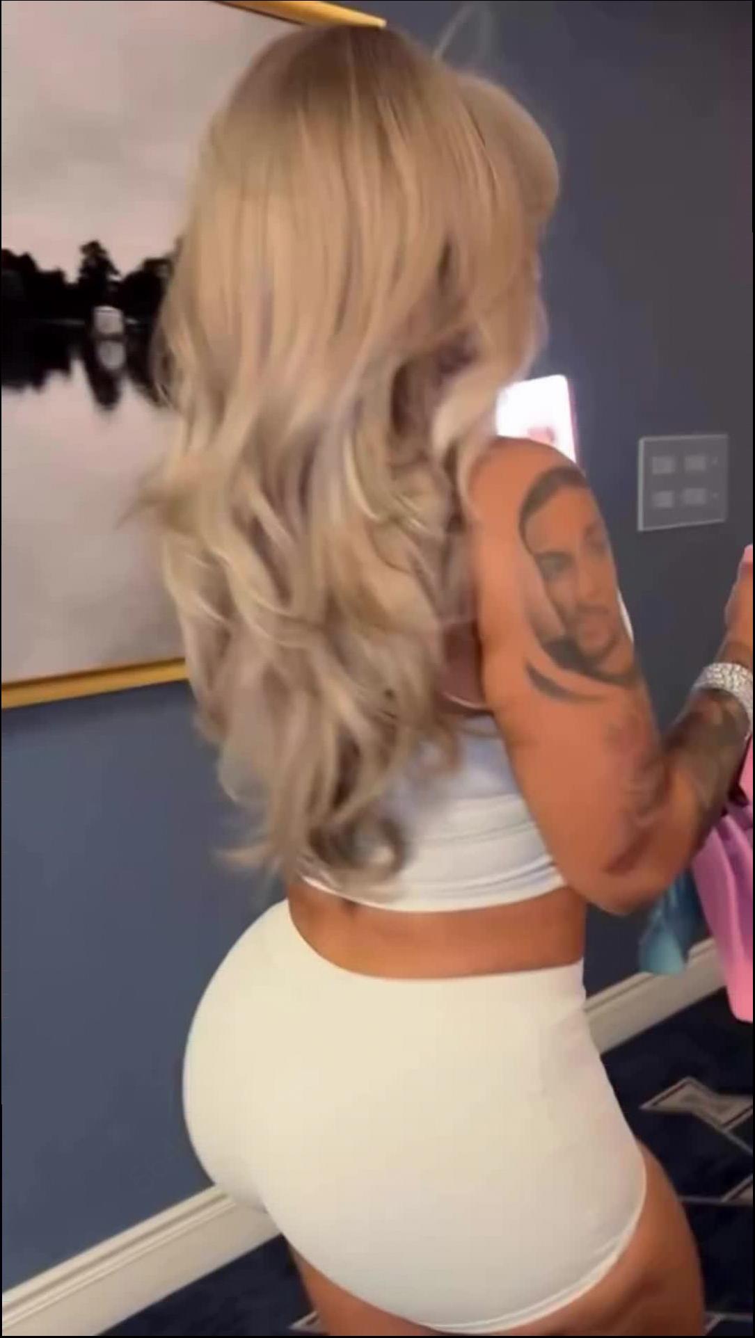 a woman is holding a white towel and a blue and white object