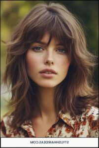 a woman with a black hair and a blue tie