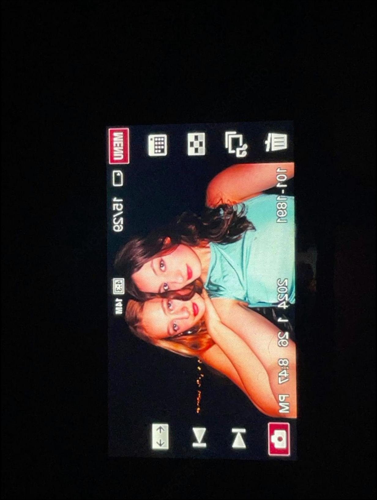 a woman is holding a tv remote in her hand