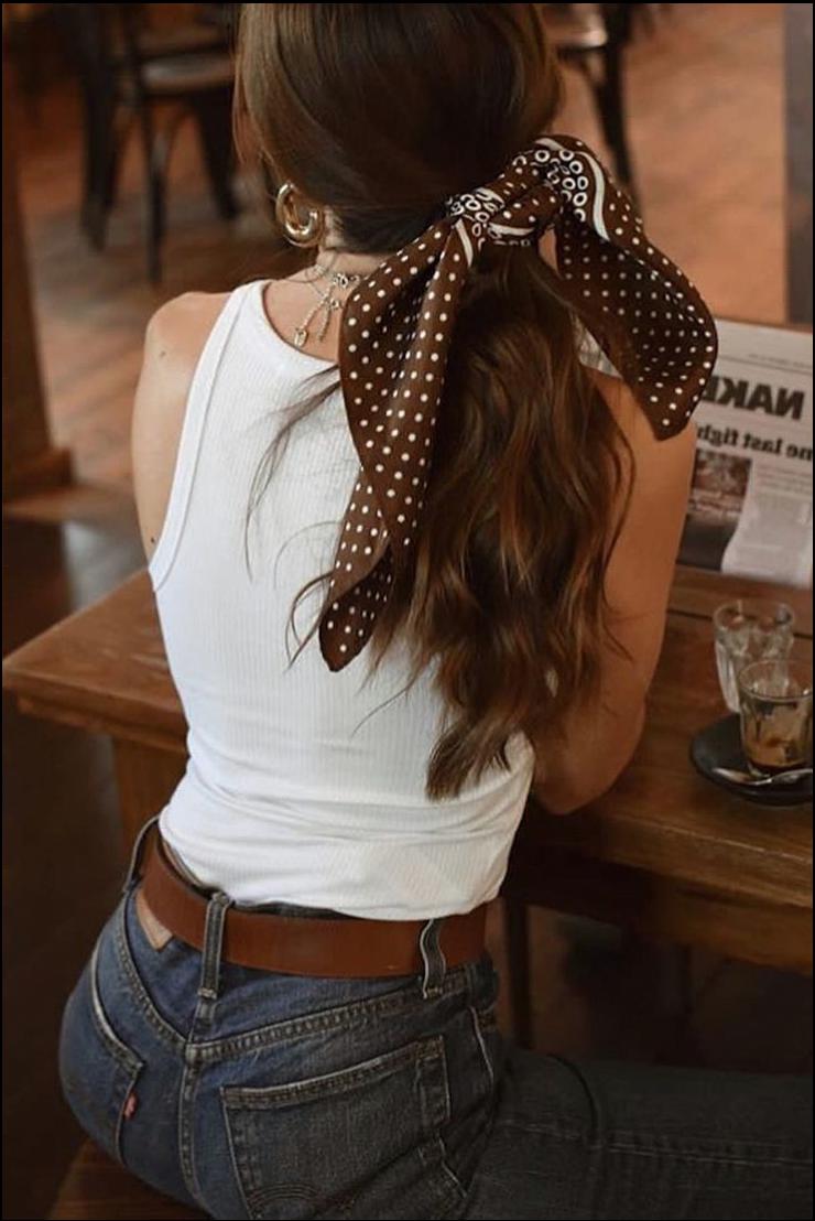 a woman wearing a black shirt and a white tie