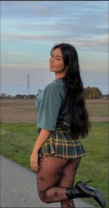 a woman in a blue dress and a black skirt