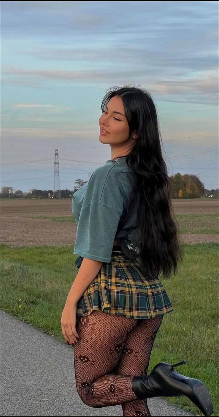 a woman in a blue dress and a black skirt