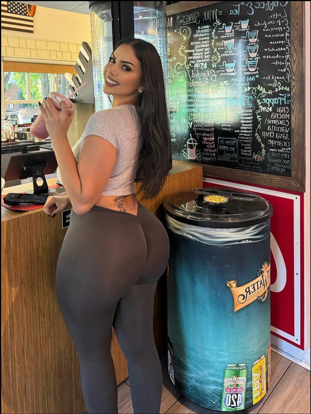 a woman standing next to a wall with a stuffed animal