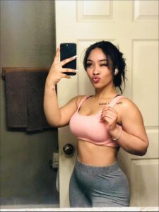 a woman is holding a cell phone in her hand