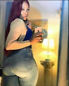 a woman is standing in a room with a cell phone