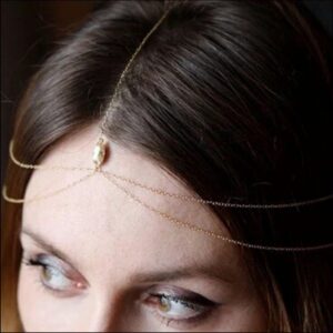 a woman with a red hair is wearing a black dress