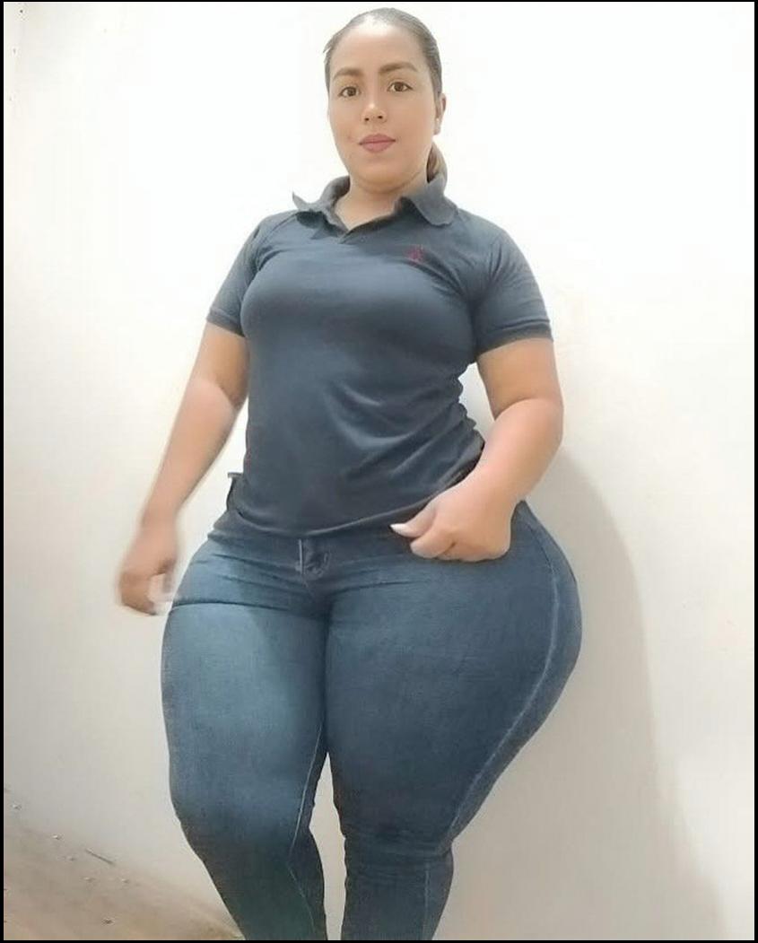 a woman is standing on a wall with a white shirt