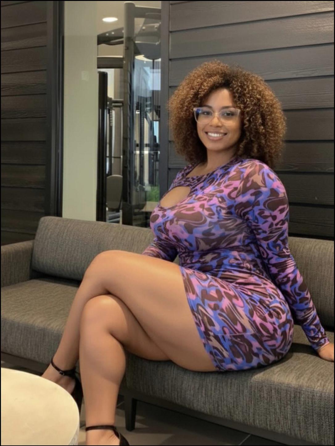 a woman in a red dress sitting on a couch