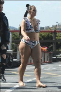 a woman in a bikini on a city street