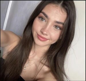 a woman is posing for a picture in a mirror