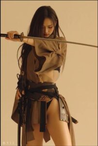 a woman is holding a stick and a rope