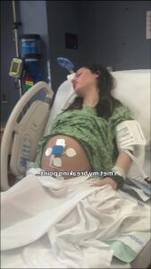 a woman is laying in a hospital bed