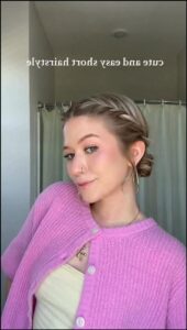 a woman is wearing a pink shirt and a blue tie