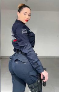 a woman in a blue dress is standing on a wall