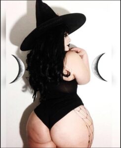 a woman in a black dress and a black hat