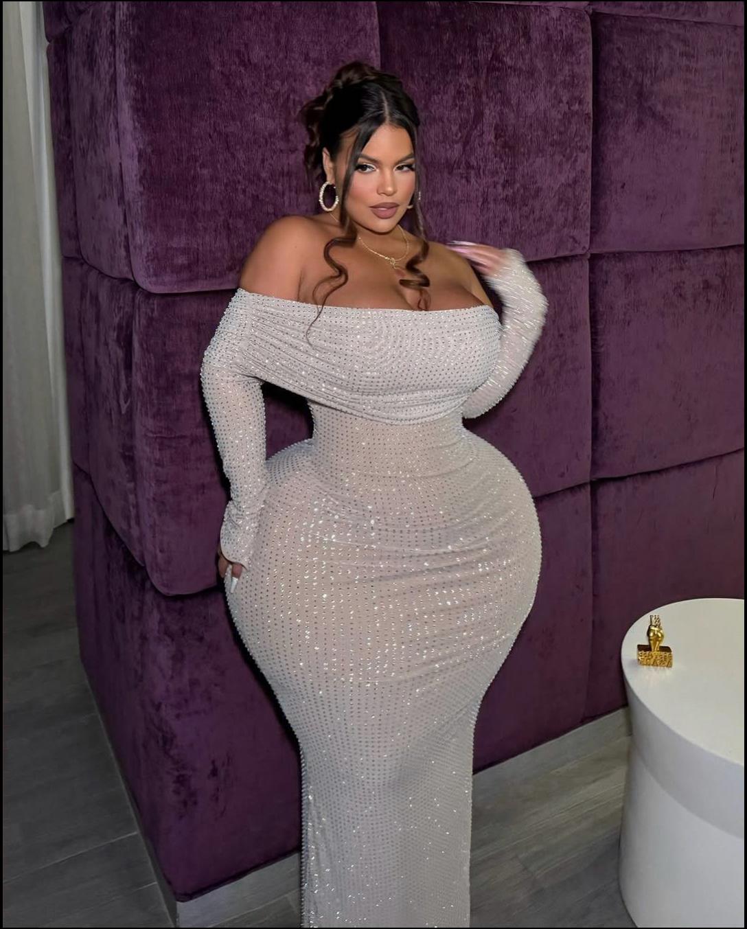 a woman in a pink dress sitting on a toilet