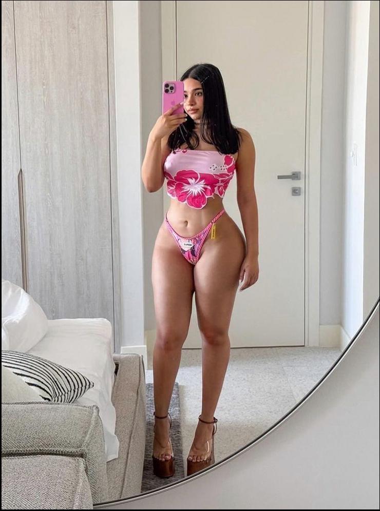 a woman in a pink dress is on a mirror