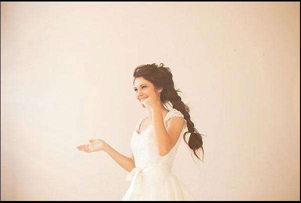 a woman is standing in a room with a white wall