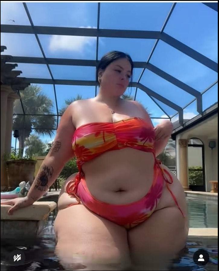 a woman in a bikini is in a pool