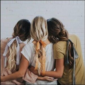 two women are looking at a cat