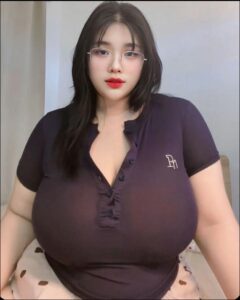 a woman with a red tie sitting on a white chair