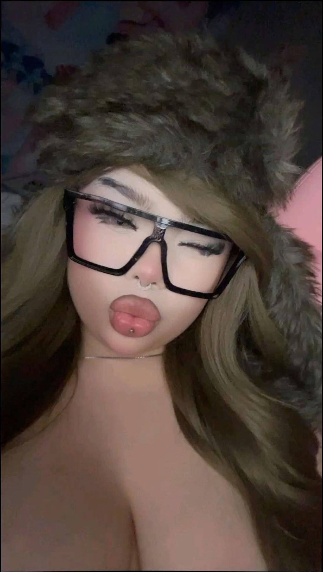 a woman wearing a black hat and a red scarf