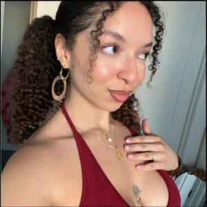a woman is brushing her teeth in a room