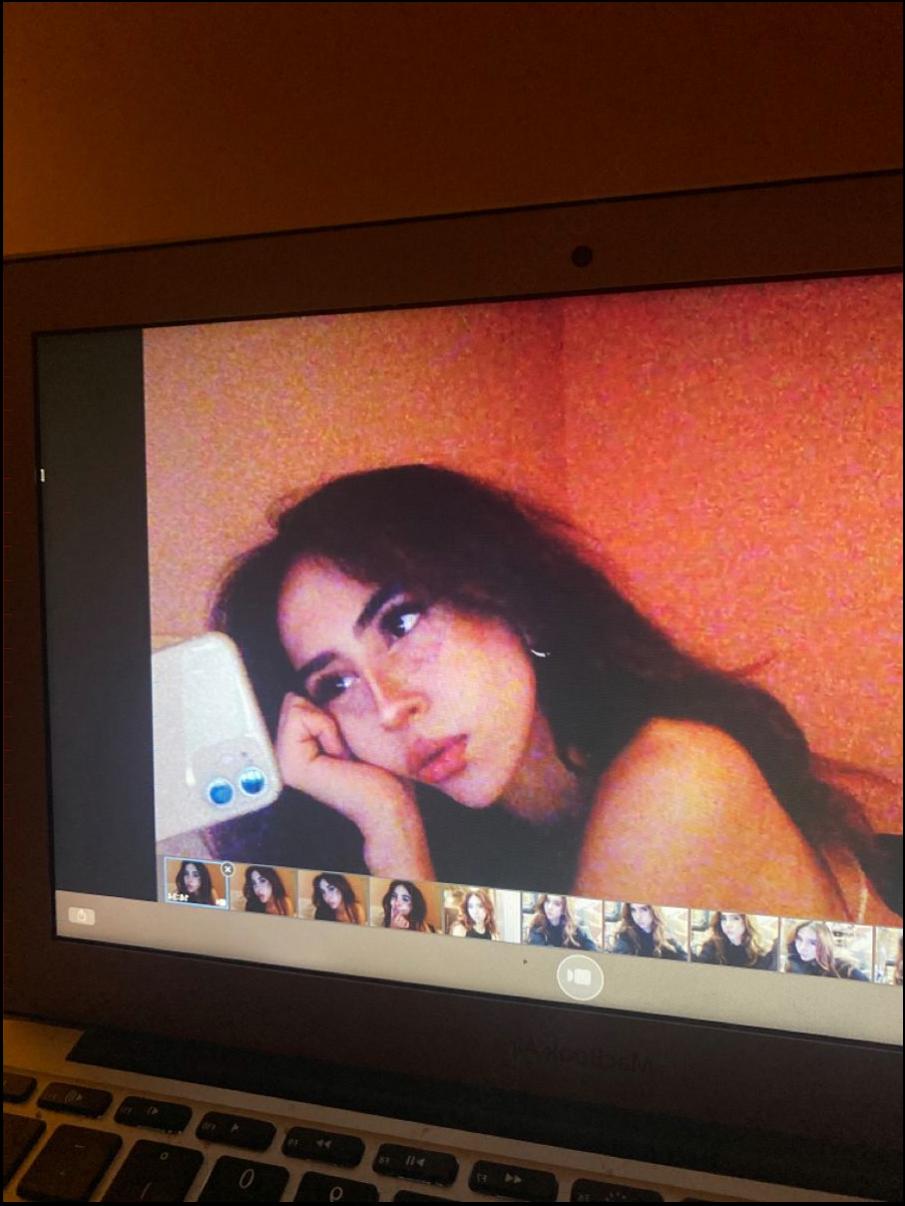 a woman sitting on a couch with a tv