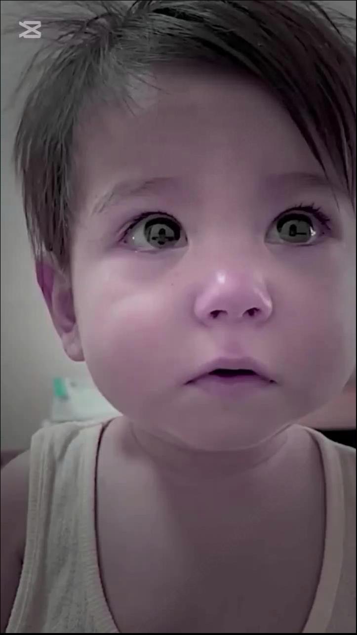 a young girl is smiling and holding a white object