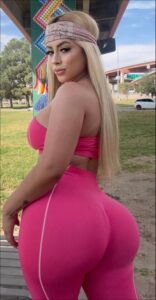 a woman wearing a pink dress and a pink hat