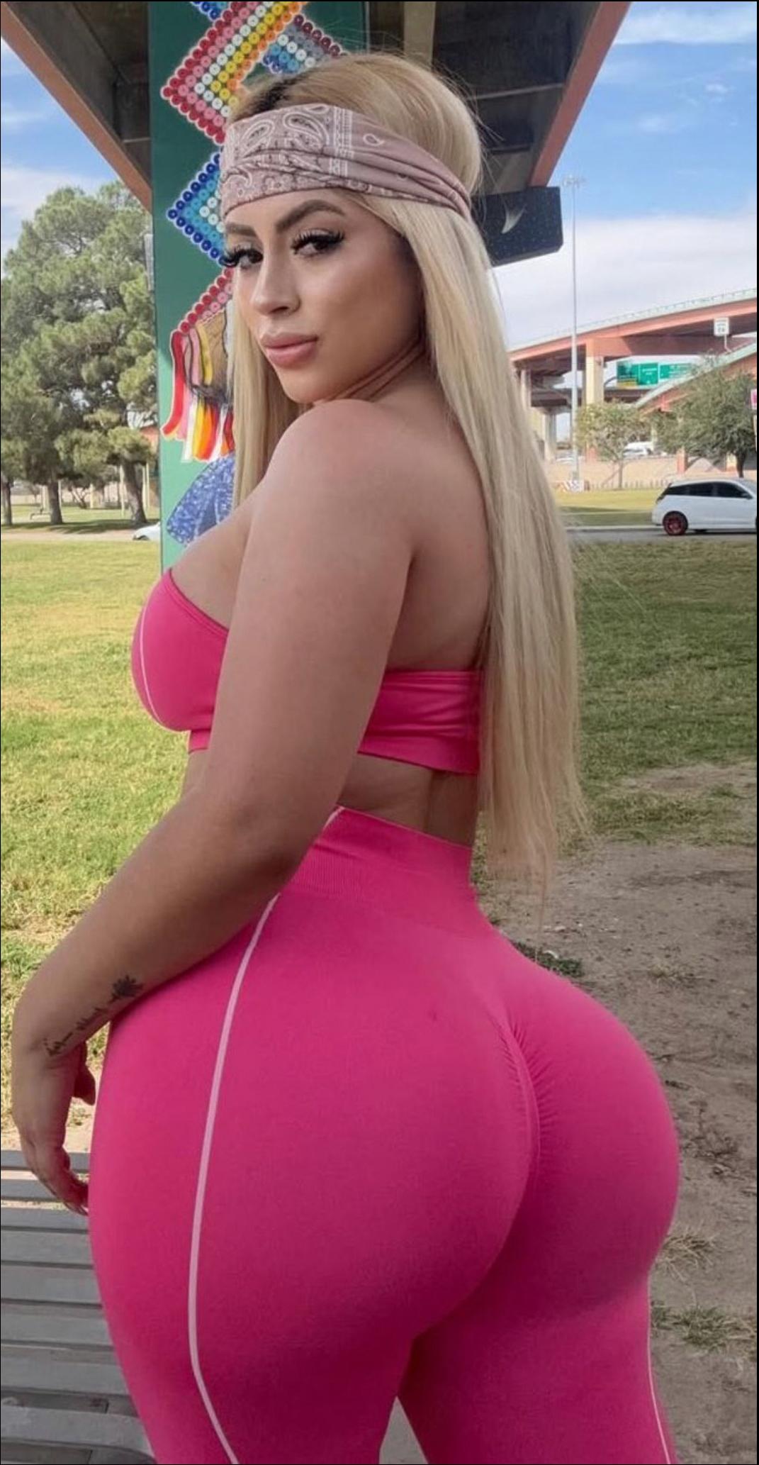 a woman wearing a pink dress and a pink hat