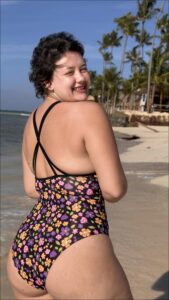 a woman in a bikini standing on a beach