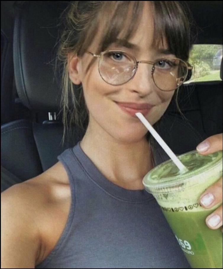 a woman holding a drink in her hand