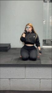 a woman is sitting on a bench and talking on a cell phone