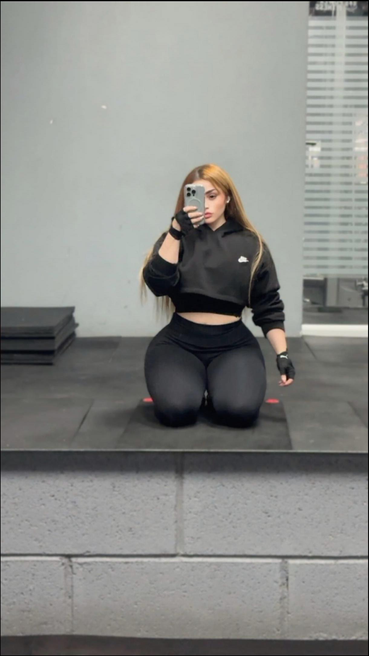 a woman is sitting on a bench and talking on a cell phone