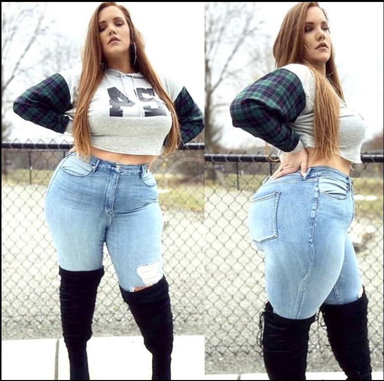 a woman in a black shirt and black shorts posing for a picture