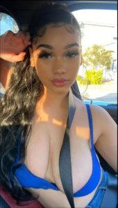 a woman in a blue dress sitting in a car