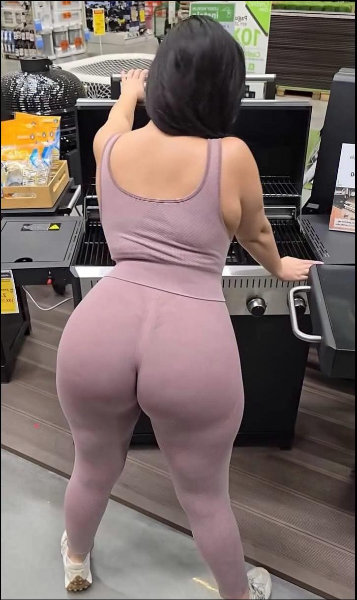 a woman in a pink dress is standing in a store