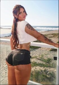 a woman in a bikini standing on a beach