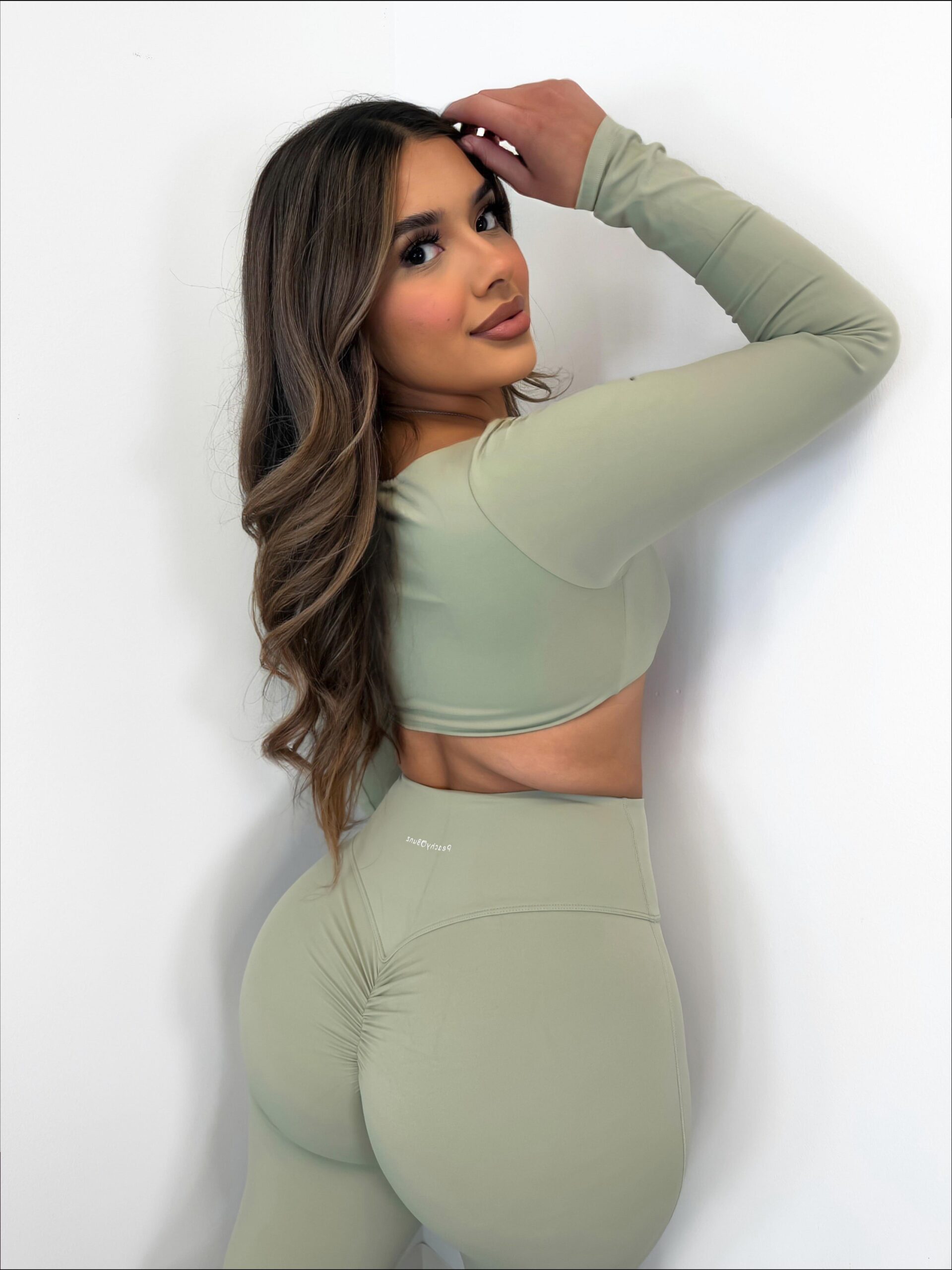 a woman in a white shirt and black pants posing for a picture