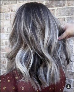 a woman is wearing a black and white striped shirt