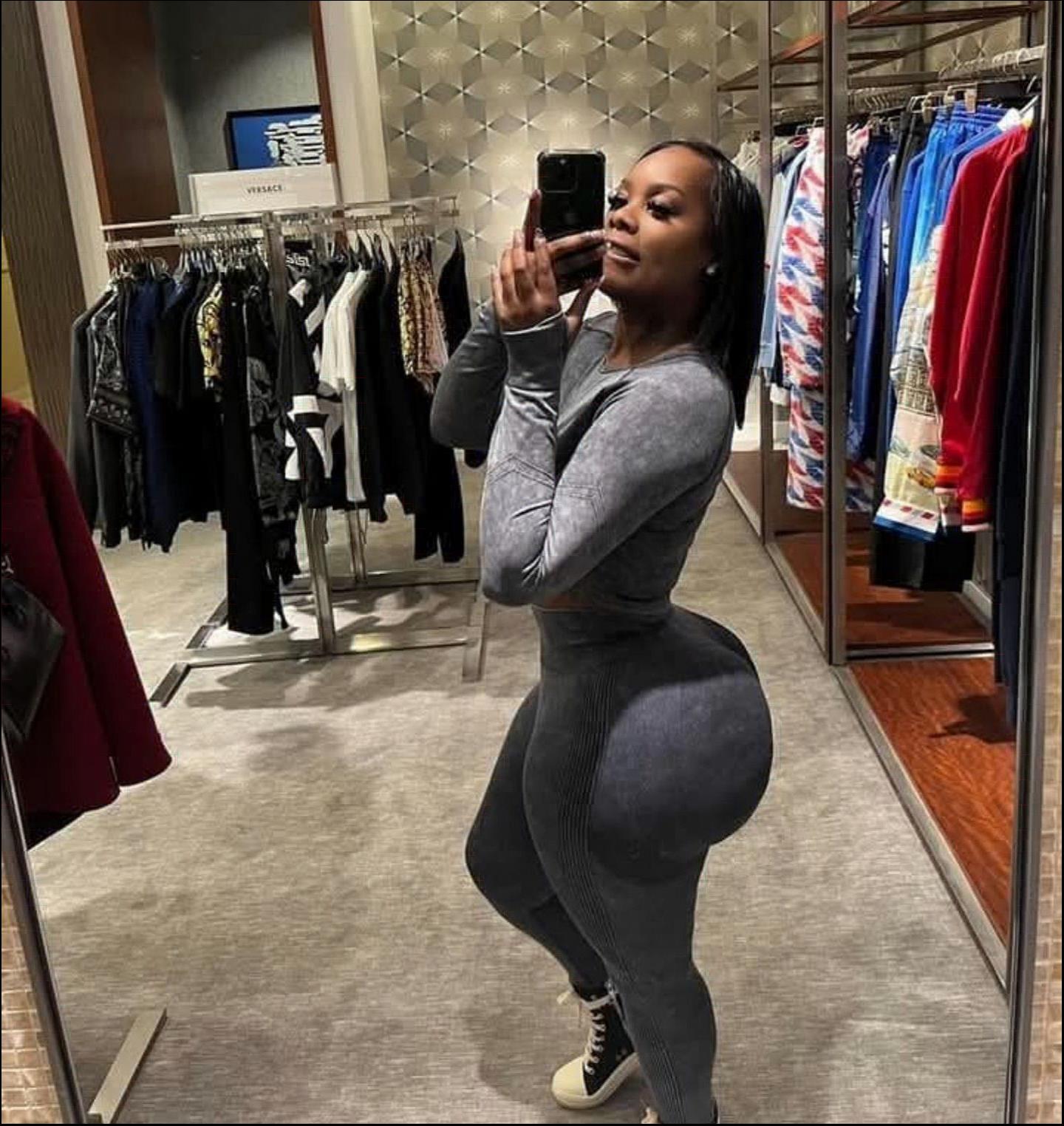 a woman is standing in a store with a camera