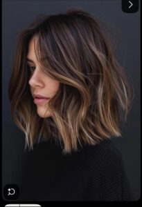 a woman is looking at the camera while holding a black object