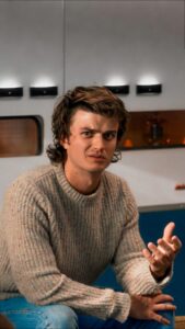 a man sitting on a bench with a cell phone